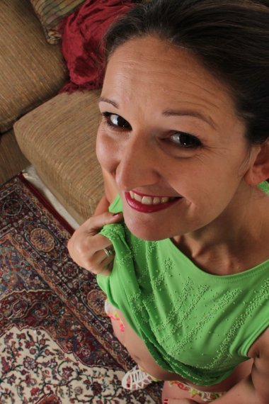 Cute American housewife stripping at home