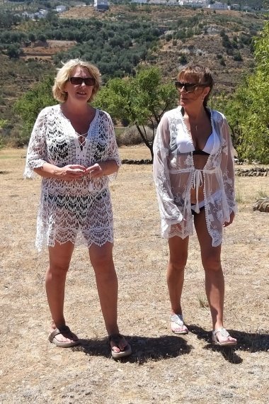 Two mature lesbians are licking in an open field in the sun